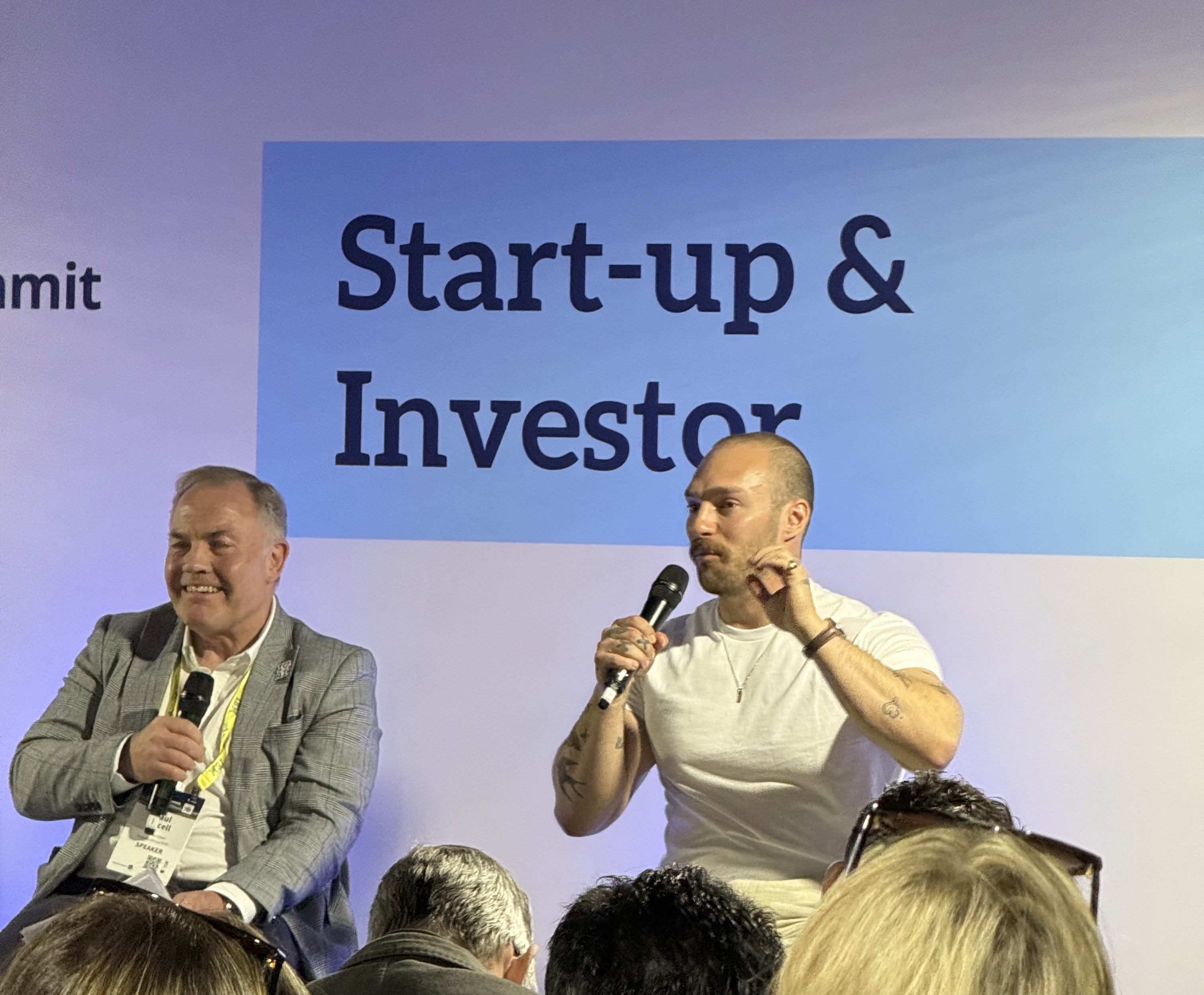Two speakers on stage at a Start-up & Investor summit